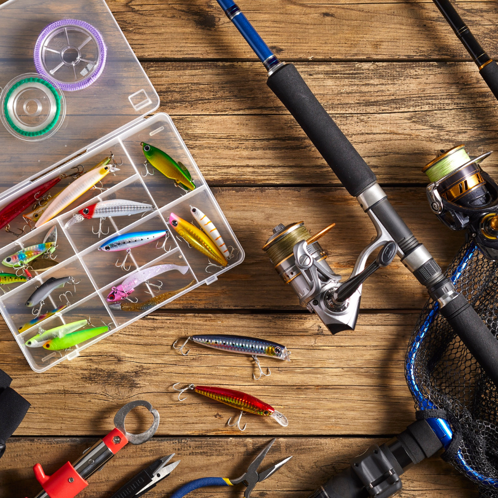 Fishing rod, reel, and lures on a wooden surface


